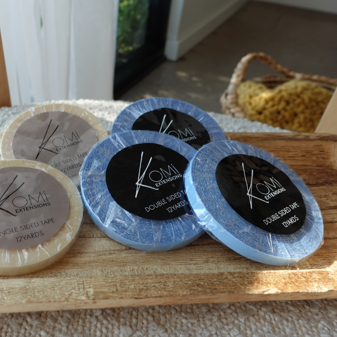 Komi extensions, Double-sided tape packaging on a wooden surface