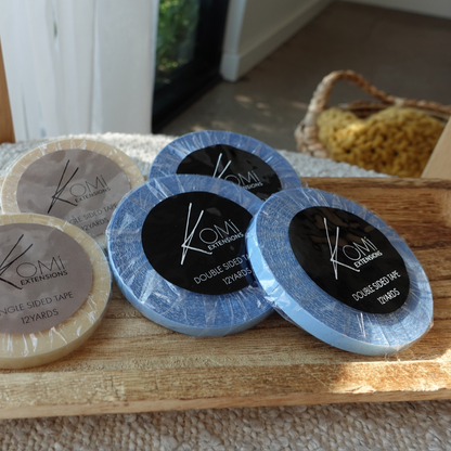 Komi extensions, Double-sided tape packaging on a wooden surface