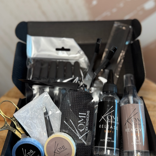 Open Komi Extensions Tape Weft Kit box containing tape wefts, color ring, release sprays, and application tools.